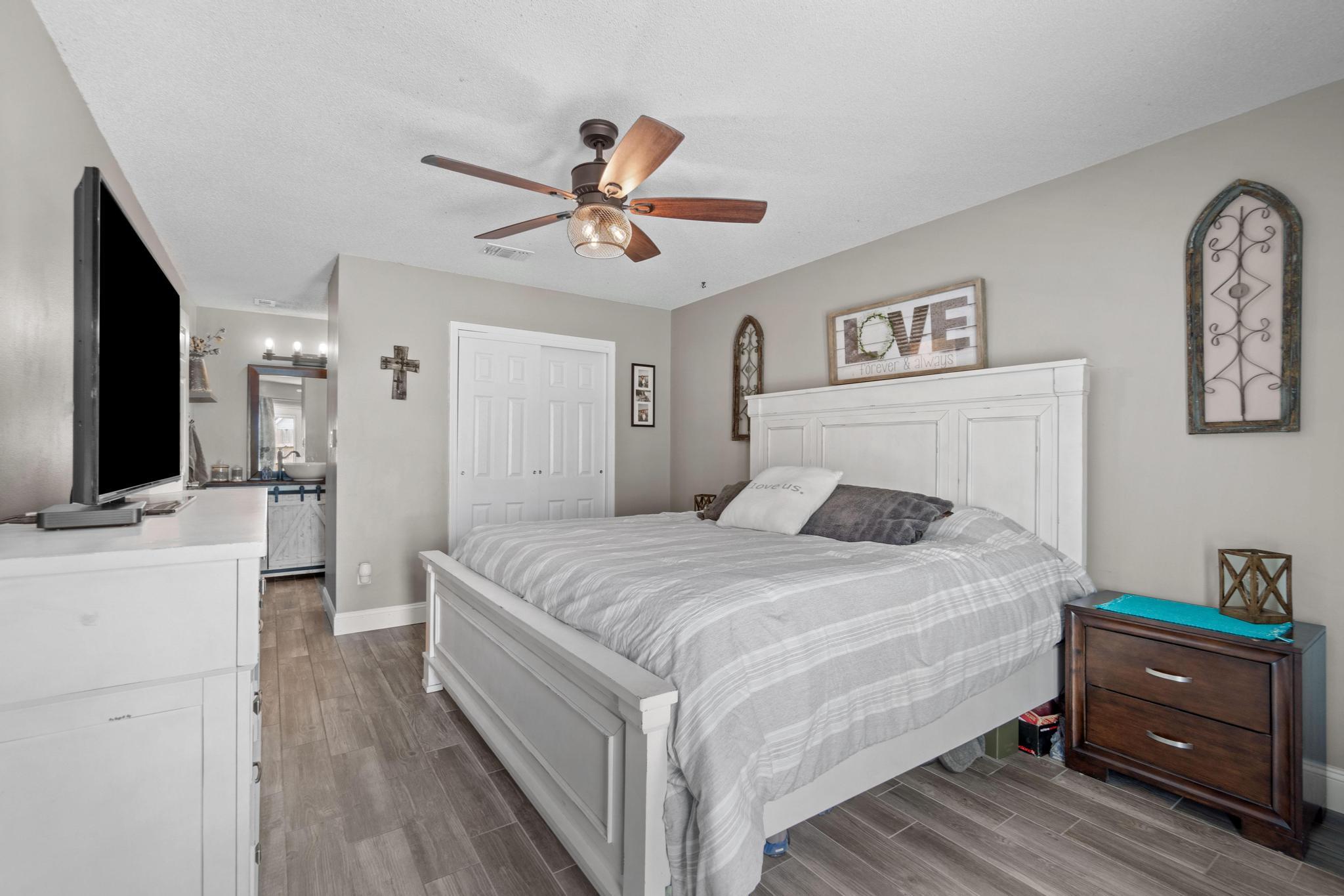 1833 Hunters Path Fort Walton Beach, FL 32547 - Photo 16 of 34 a bedroom with a bed and a flat screen tv