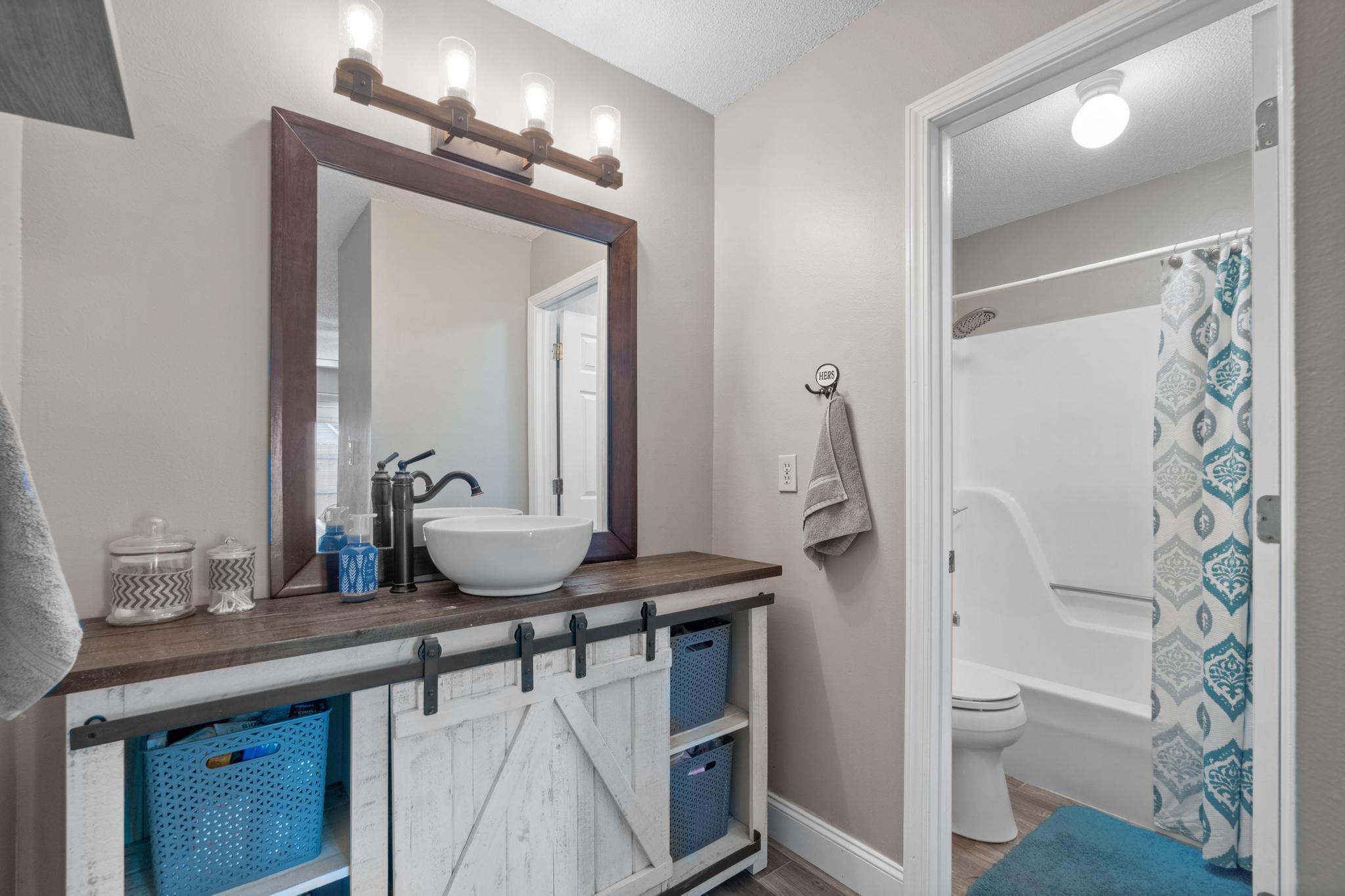 1833 Hunters Path Fort Walton Beach, FL 32547 - Photo 17 of 34 a bathroom with a granite countertop sink a toilet a mirror and shower