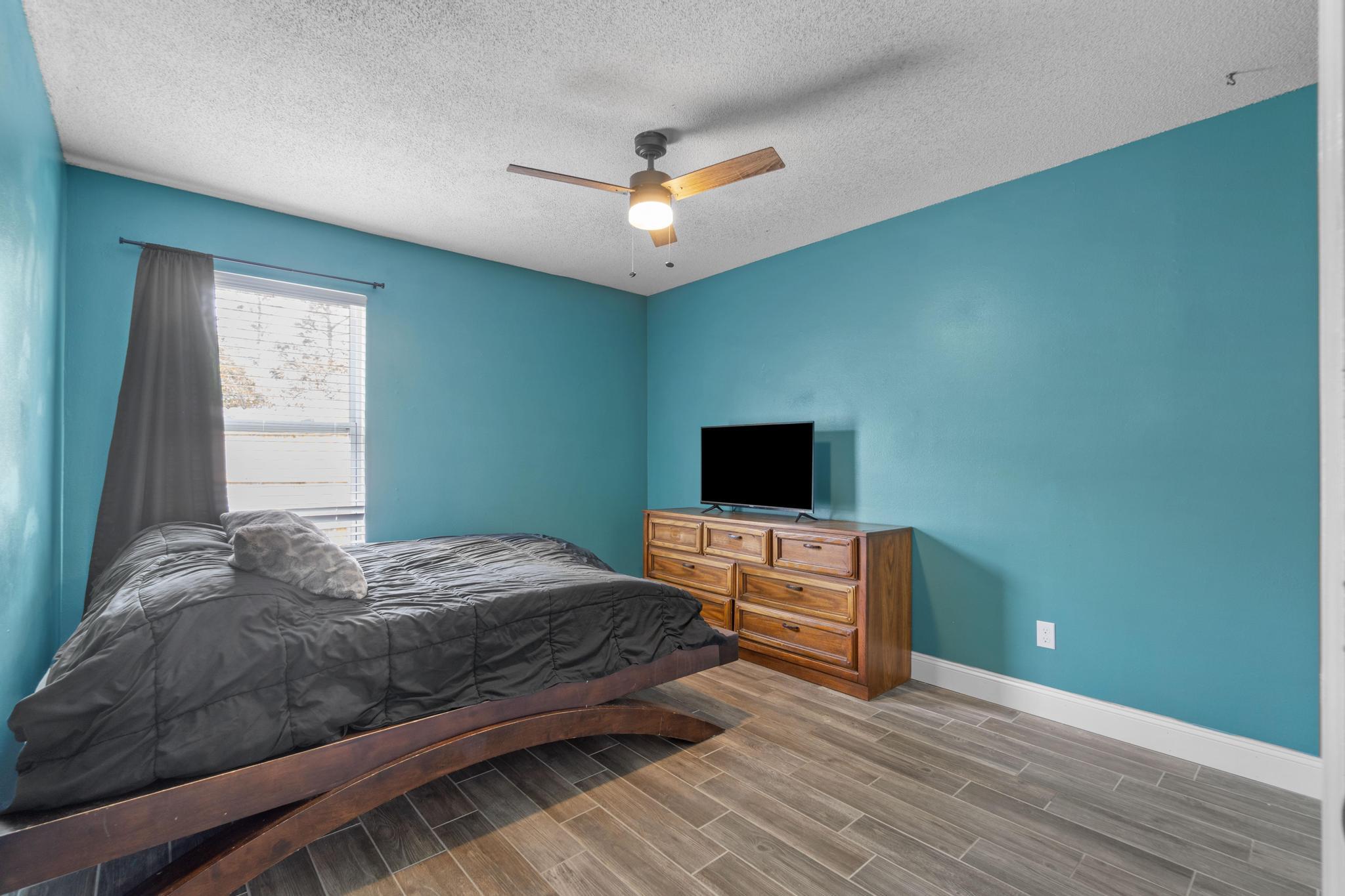 1833 Hunters Path Fort Walton Beach, FL 32547 - Photo 19 of 34 a bedroom with a bed and a flat screen tv