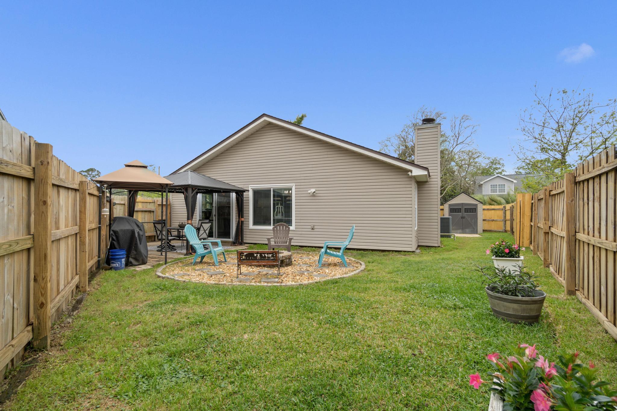 1833 Hunters Path Fort Walton Beach, FL 32547 - Photo 2 of 34 a front view of a house with garden and porch