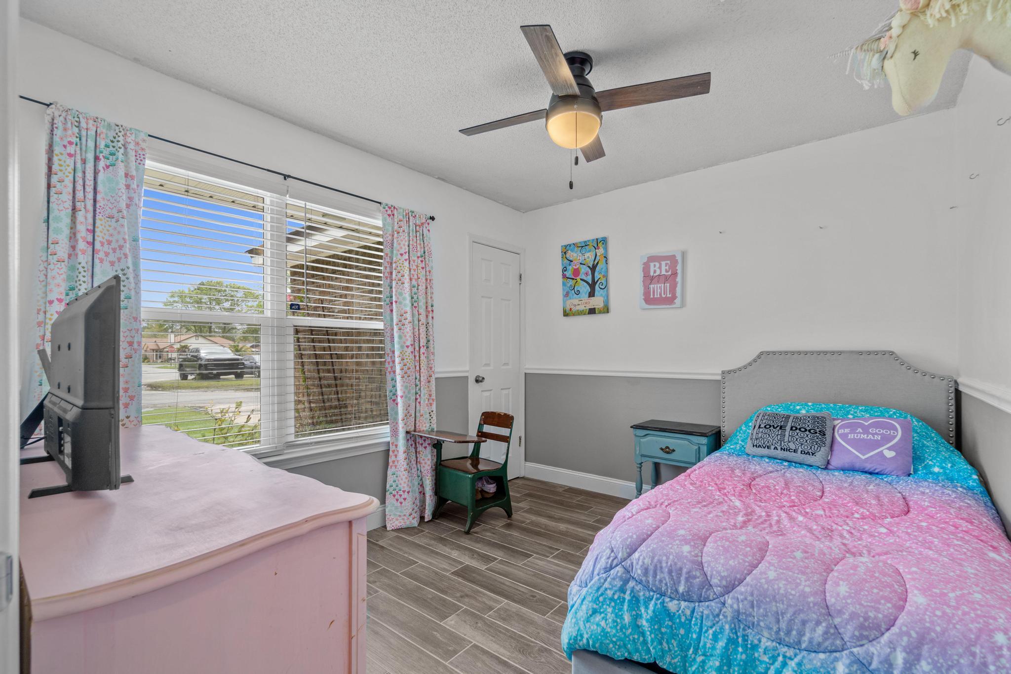 1833 Hunters Path Fort Walton Beach, FL 32547 - Photo 21 of 34 a bedroom with a bed and a chandelier