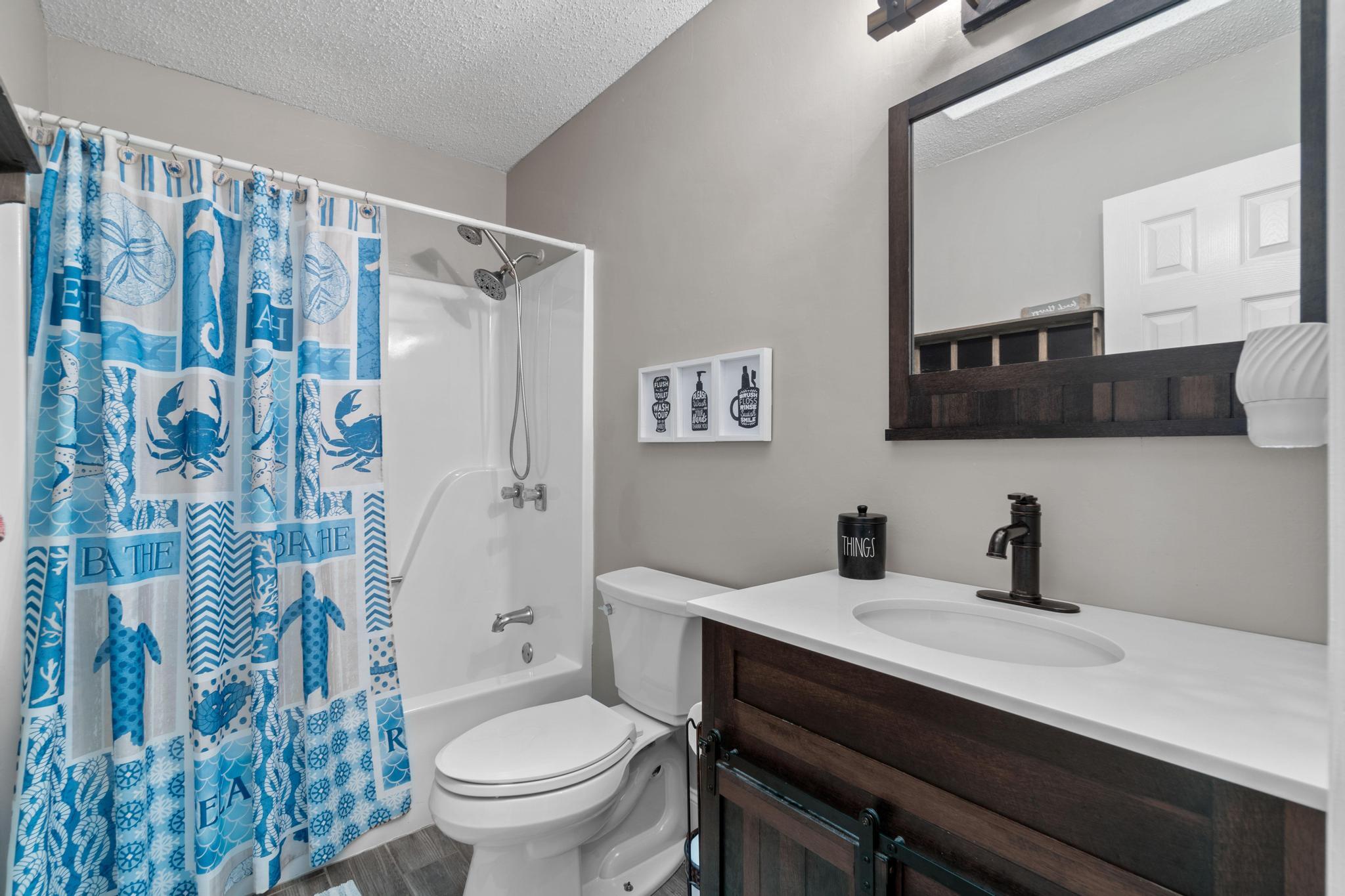 1833 Hunters Path Fort Walton Beach, FL 32547 - Photo 24 of 34 a bathroom with a toilet a sink and a mirror