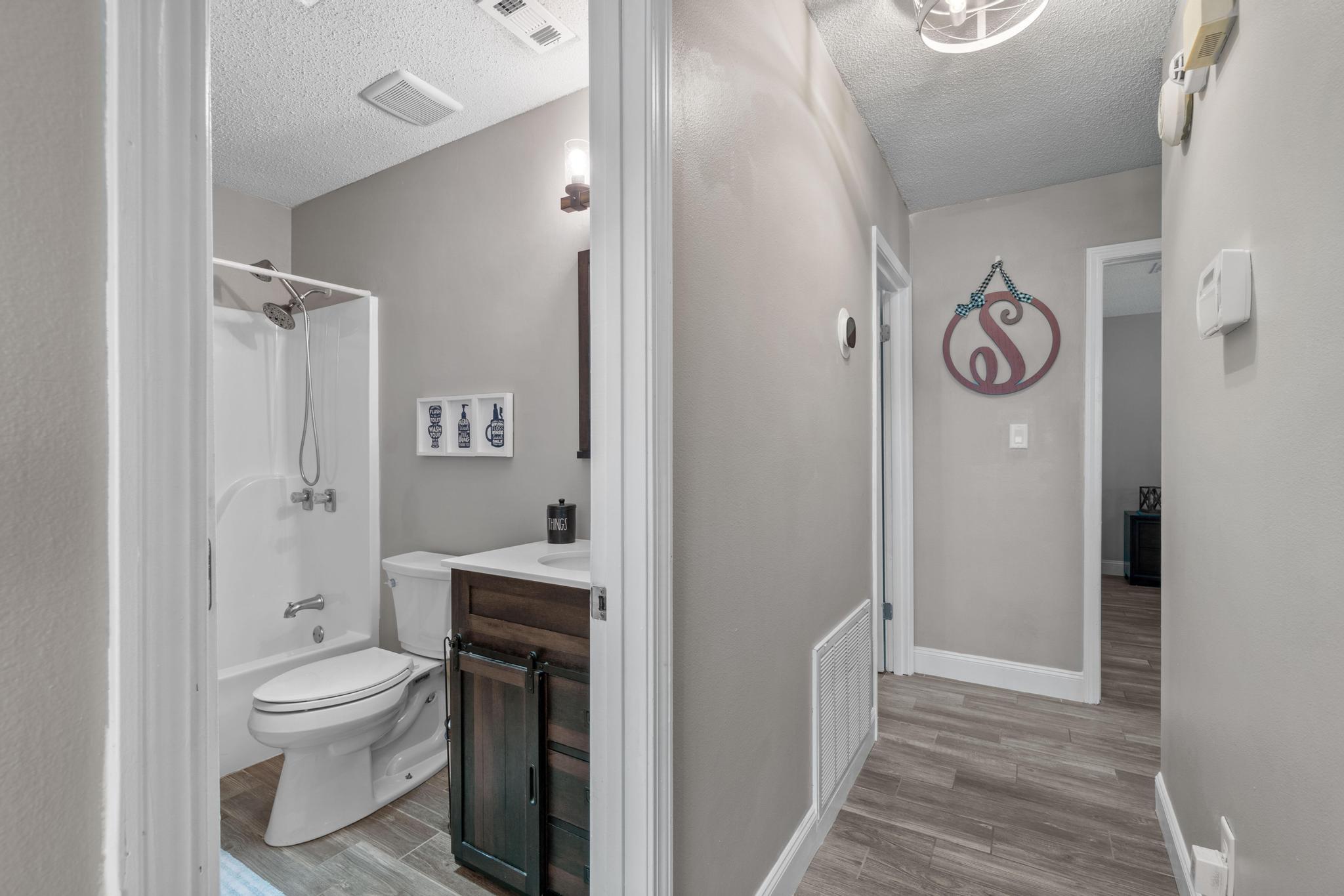 1833 Hunters Path Fort Walton Beach, FL 32547 - Photo 25 of 34 a bathroom with a toilet a sink and a shower