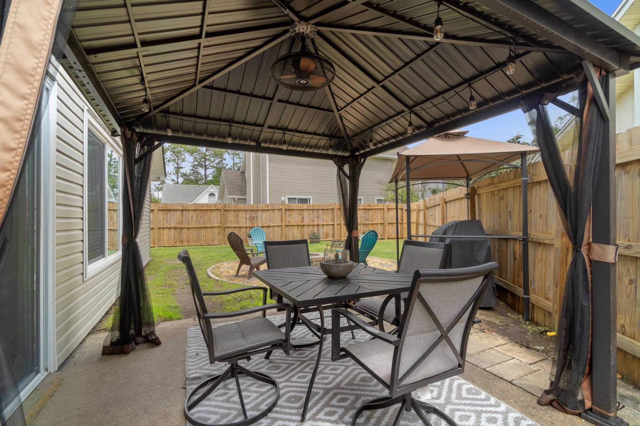 1833 Hunters Path Fort Walton Beach, FL 32547 - Photo 28 of 34 a patio with a patio table and chairs