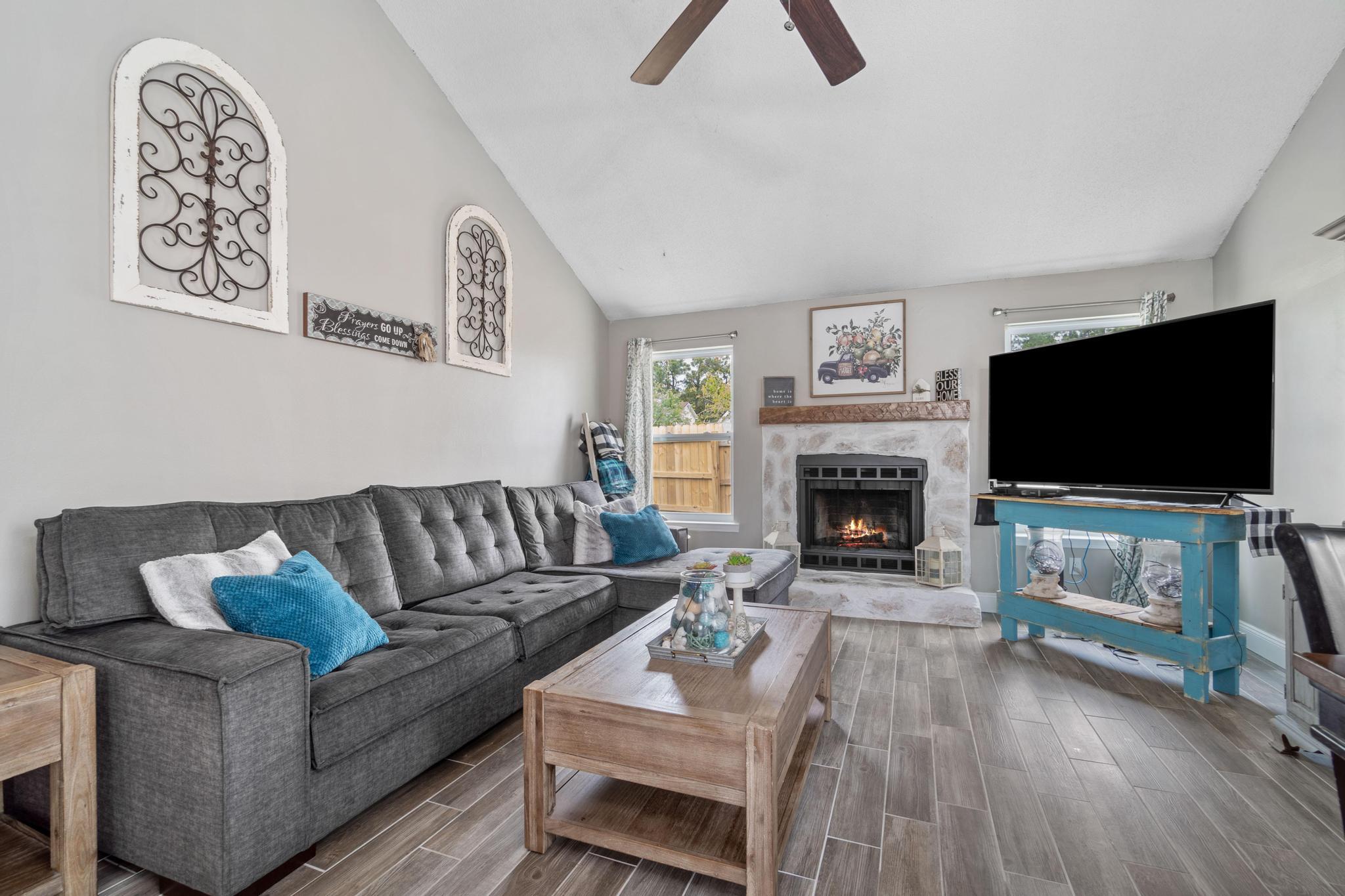 1833 Hunters Path Fort Walton Beach, FL 32547 - Photo 6 of 34 a living room with furniture a flat screen tv and a fireplace