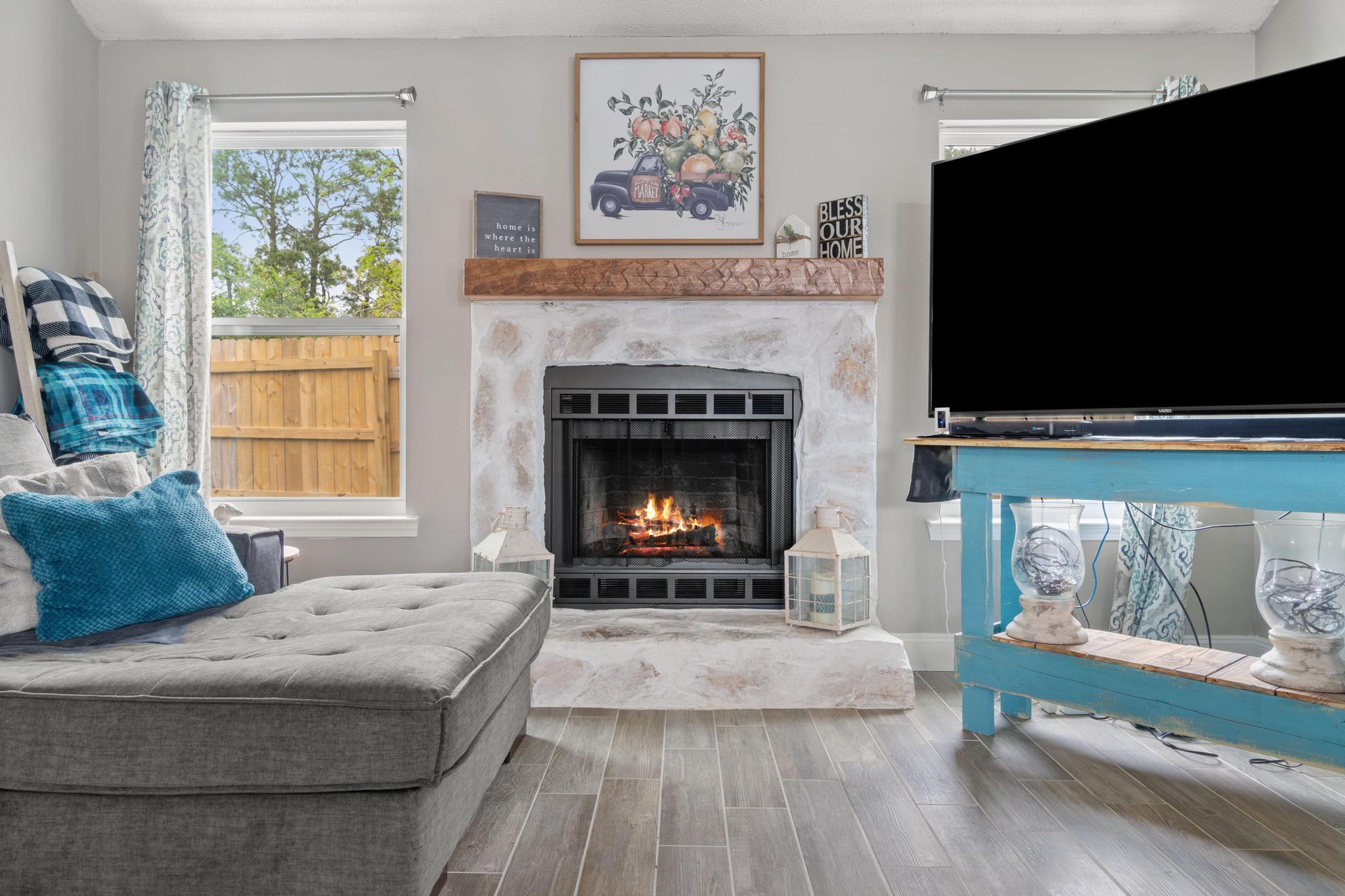 1833 Hunters Path Fort Walton Beach, FL 32547 - Photo 7 of 34 a living room with a fireplace a flat screen tv and a fireplace