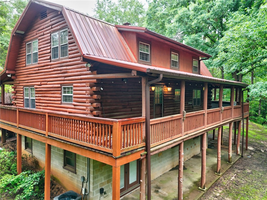237 Spring Valley Road Liberty, SC 29657 - Photo 38 of 50 A spacious log home with a long, inviting wrap-around porch offers peaceful outdoor living.
