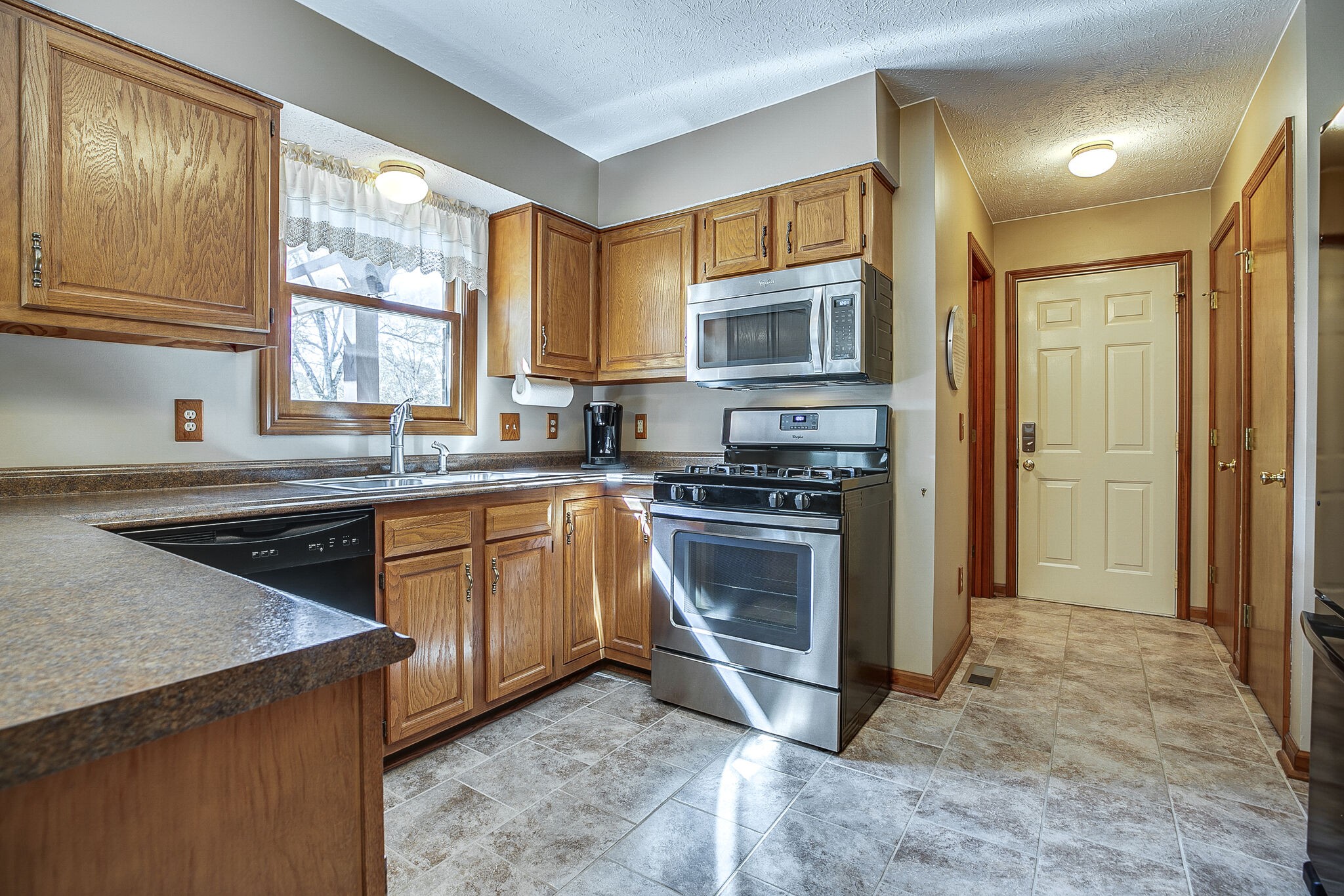 9513 Link Road Christiana, TN 37037 - Photo 12 of 34 a kitchen with stainless steel appliances granite countertop a stove a sink and a microwave