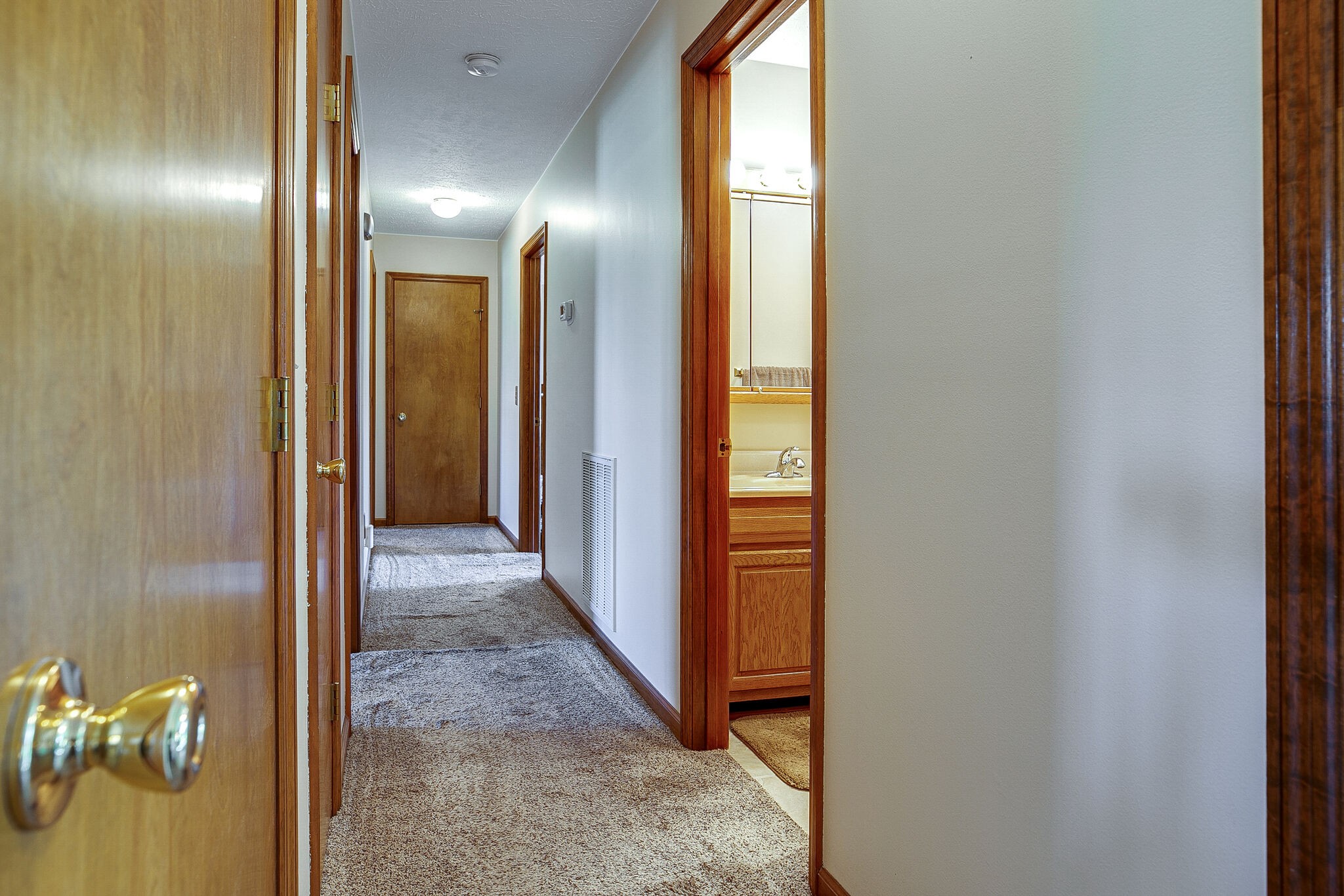 9513 Link Road Christiana, TN 37037 - Photo 15 of 34 a view of a hallway with wooden floor and a bathroom