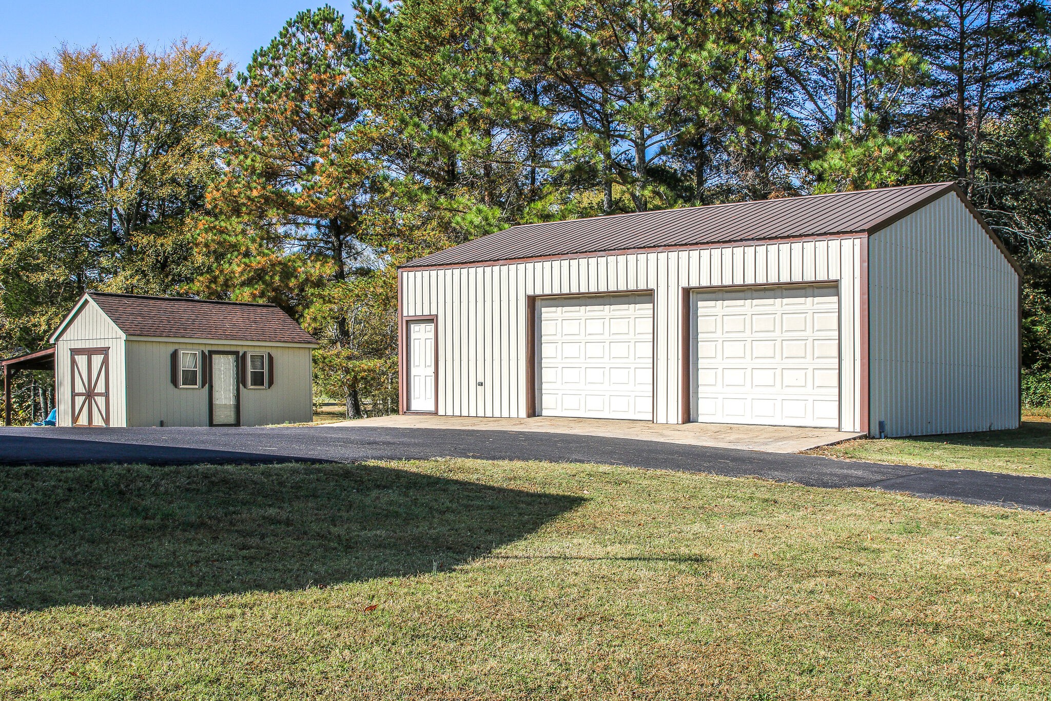 9513 Link Road Christiana, TN 37037 - Photo 5 of 34 a front view of a house with a garden and trees