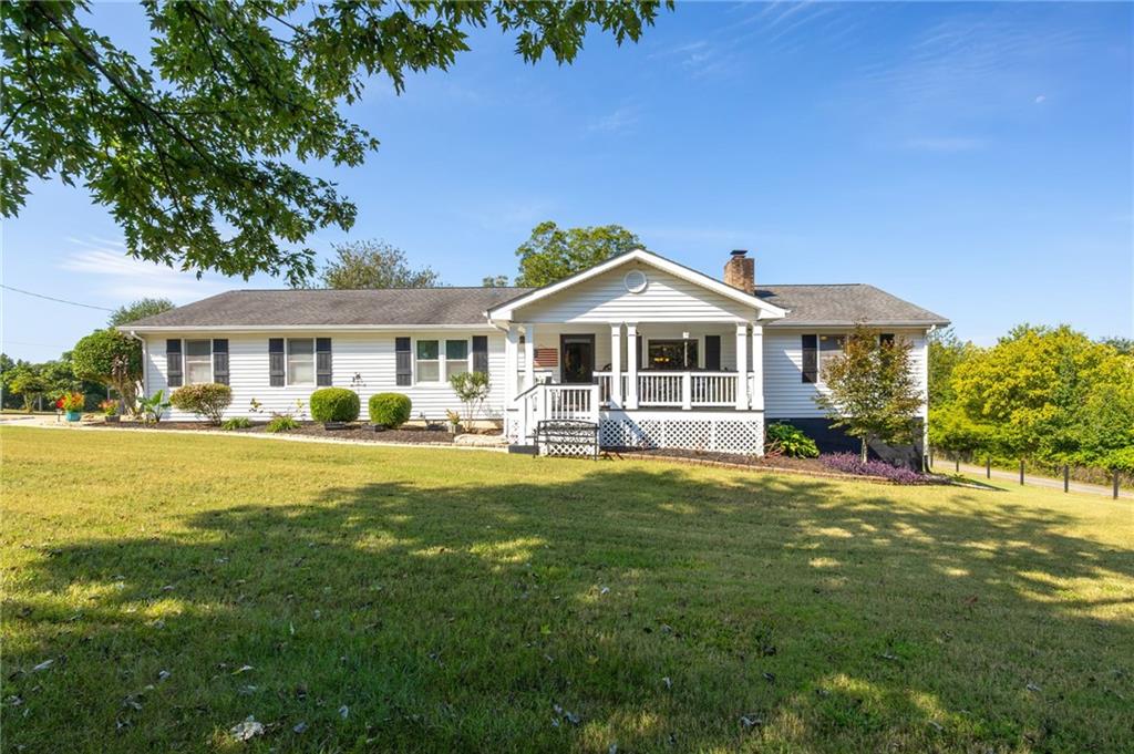 4310 Double Springs Road Southwest Monroe, GA 30656 - Photo 1 of 1 a front view of a house with a yard table and chairs