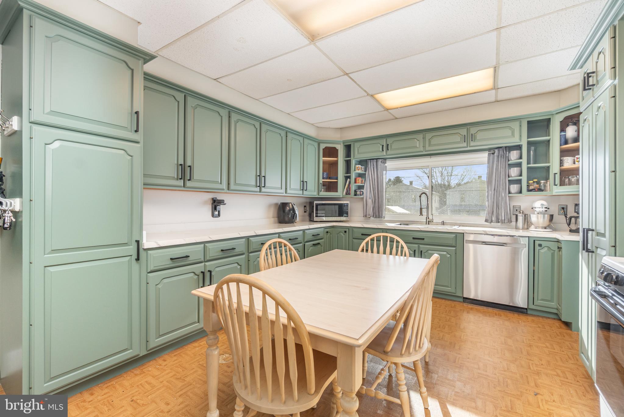 2246 Reading Avenue Reading, PA 19609 - Photo 11 of 27 a kitchen with a table chairs refrigerator and cabinets