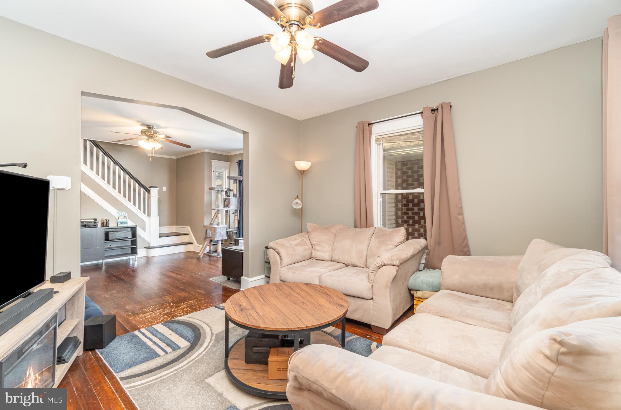 2246 Reading Avenue Reading, PA 19609 - Photo 7 of 27 a living room with furniture a ceiling fan and a flat screen tv