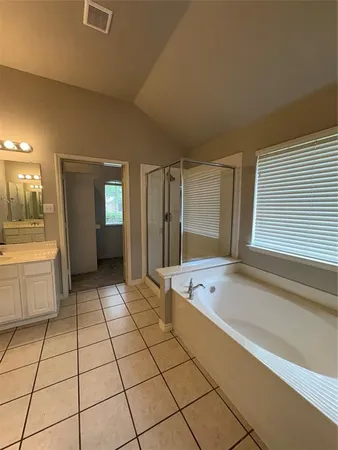 a spacious bathroom with a bathtub and a shower