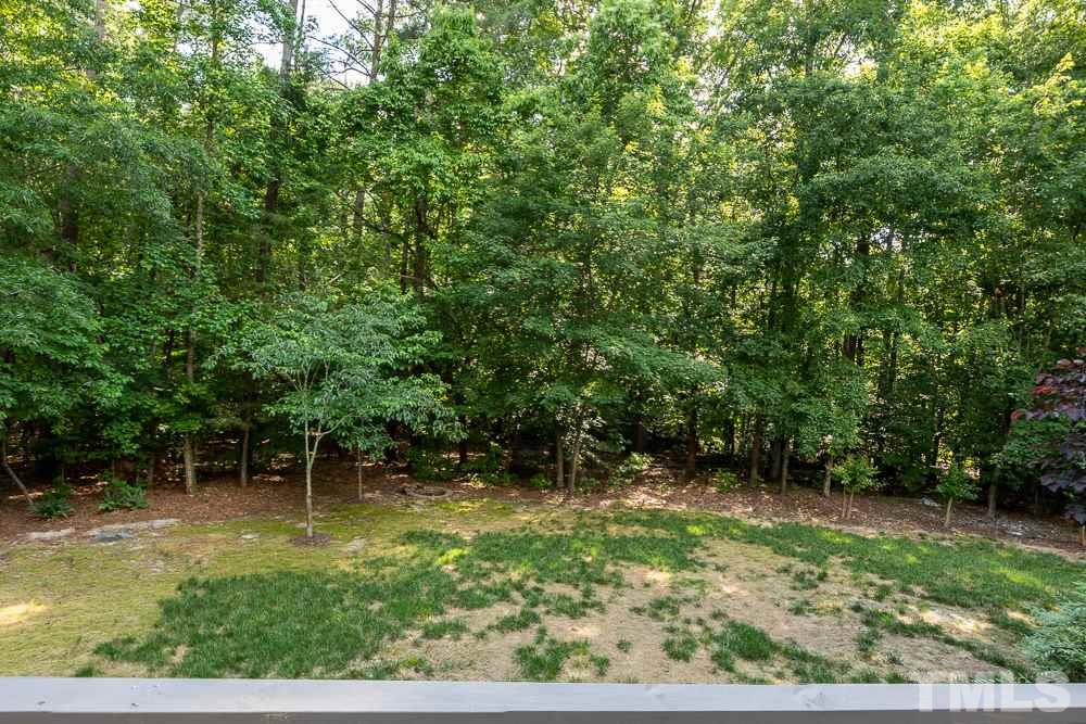 2724 Dray Court Raleigh, NC 27613 - Photo 22 of 25 a backyard of a house with lots of green space