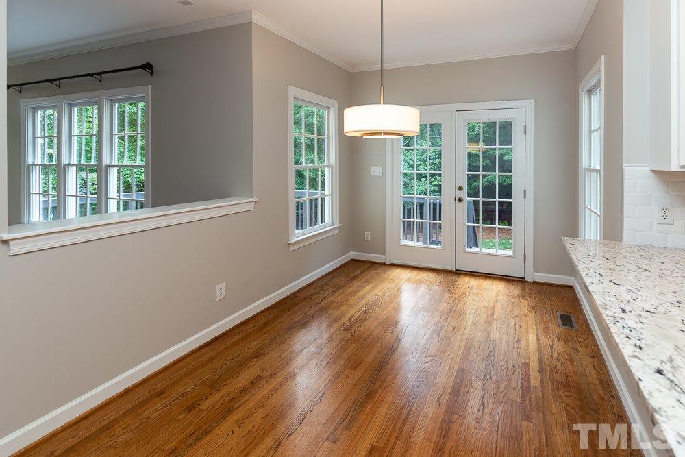 2724 Dray Court Raleigh, NC 27613 - Photo 8 of 25 an empty room with wooden floor and windows
