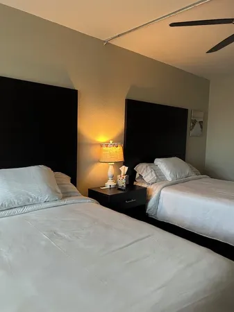 a bedroom with a bed and a flat tv screen on dresser