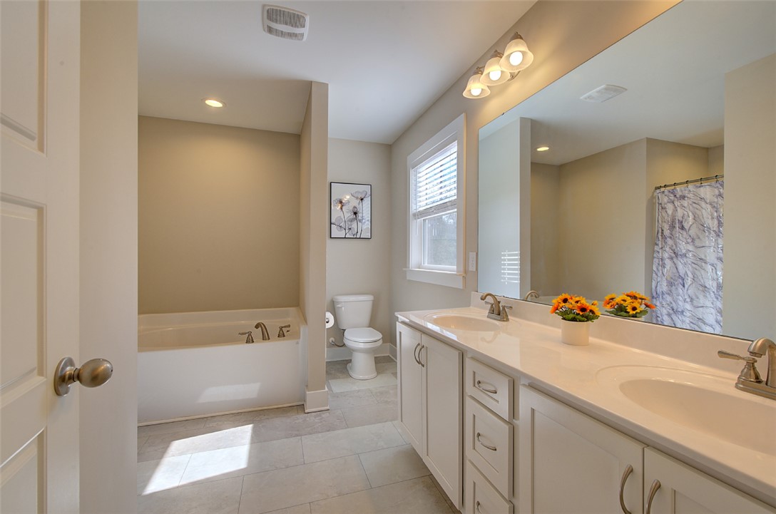 110 Sanders Drive Easley, SC 29642 - Photo 12 of 23 This bright bathroom features a spacious vanity and a relaxing soaking tub.