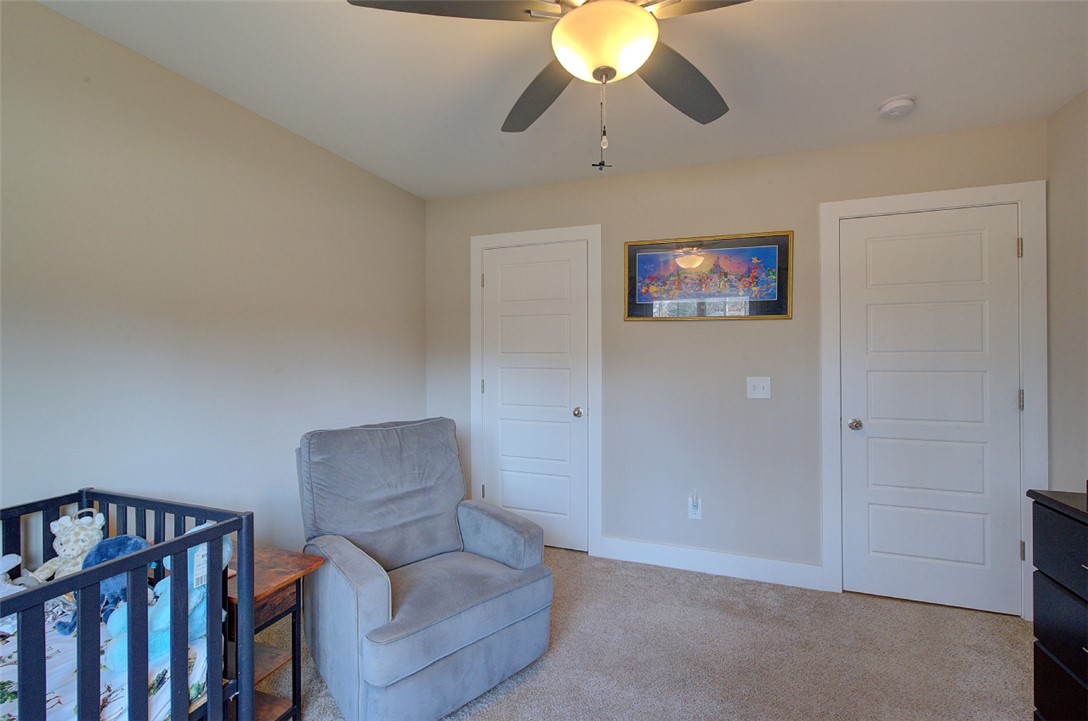 110 Sanders Drive Easley, SC 29642 - Photo 15 of 23 This cozy bedroom features comfortable carpeting, a ceiling fan, and ample natural light.