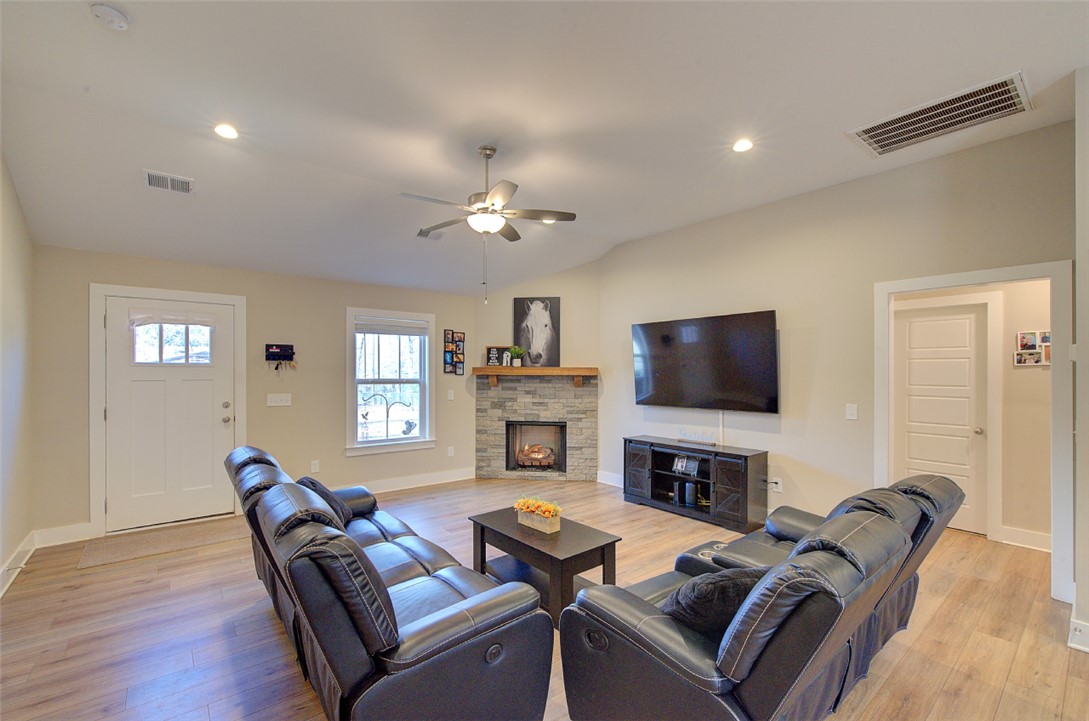 110 Sanders Drive Easley, SC 29642 - Photo 4 of 23 This inviting living area features a charming fireplace and warm wood flooring.