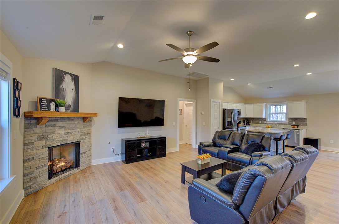 110 Sanders Drive Easley, SC 29642 - Photo 5 of 23 This inviting space features an open layout, a cozy fireplace, and rich hardwood flooring throughout.