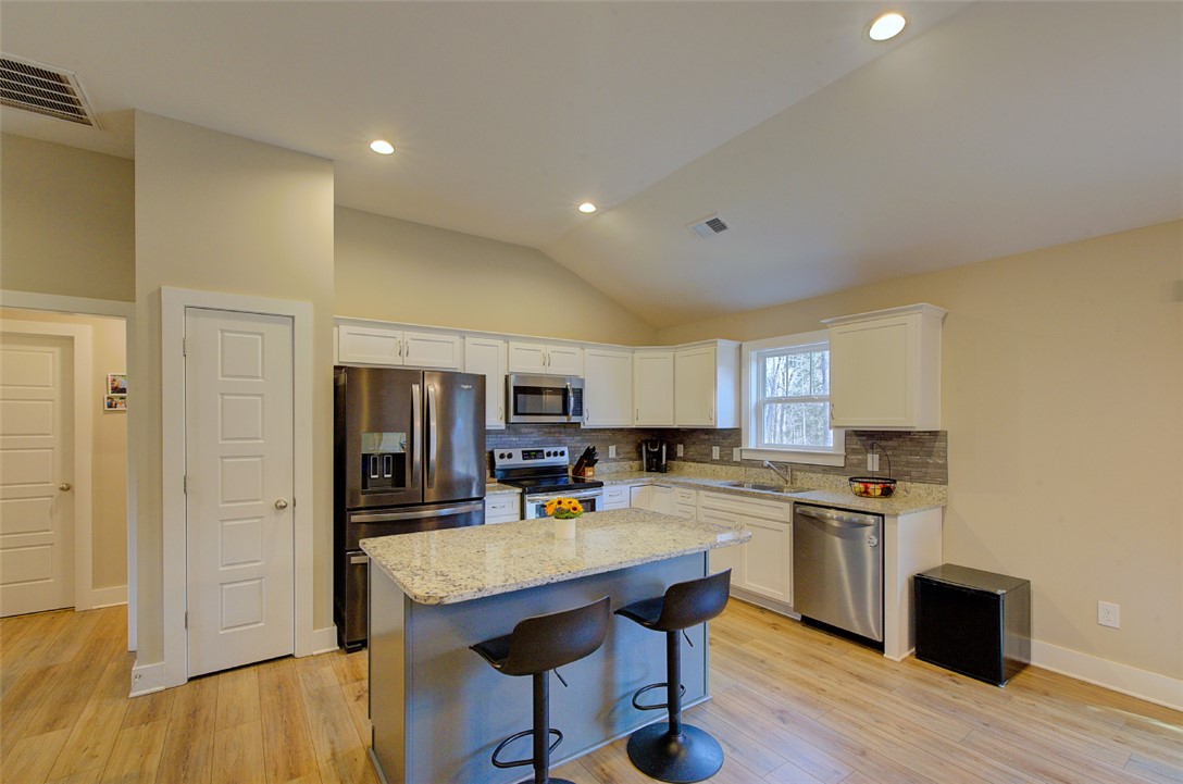 110 Sanders Drive Easley, SC 29642 - Photo 7 of 23 This bright kitchen features vaulted ceilings, ample counter space, and stainless steel appliances.