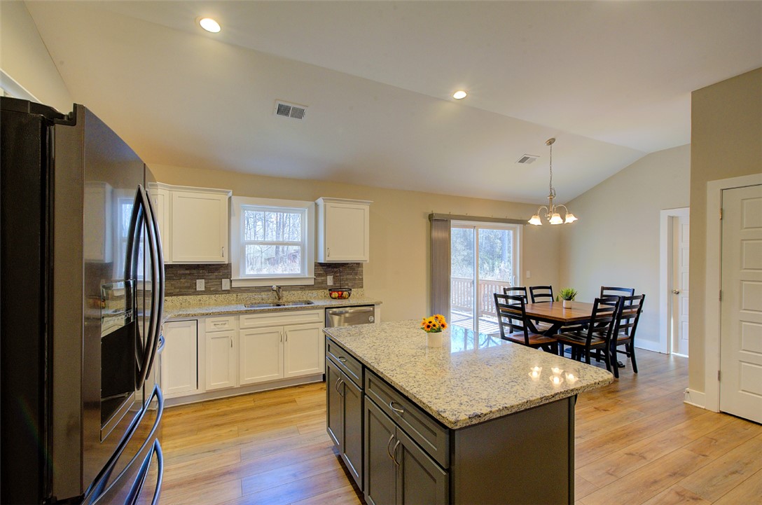 110 Sanders Drive Easley, SC 29642 - Photo 8 of 23 This spacious kitchen offers an island and an inviting dining area with outdoor access.