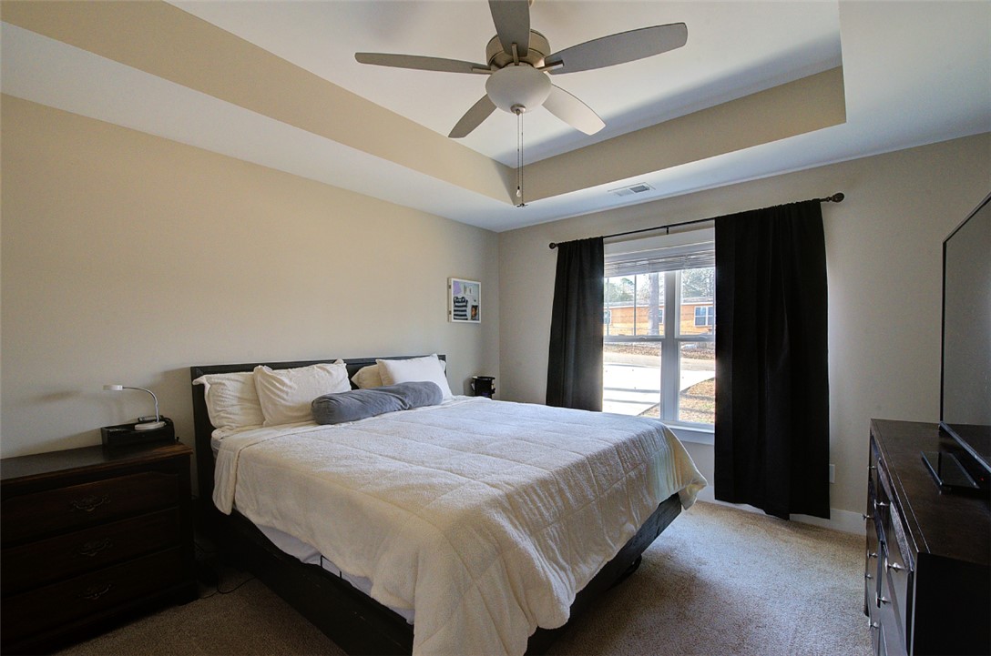 110 Sanders Drive Easley, SC 29642 - Photo 10 of 23 This spacious bedroom offers comfortable living with a well-designed ceiling and ample natural light.