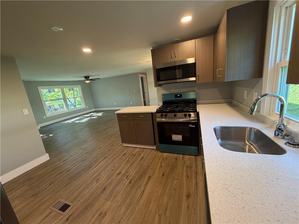19 Springridge Road Bath, PA 18014 - Photo 9 of 29 An open kitchen layout flows seamlessly into a spacious living area with durable wood flooring.
