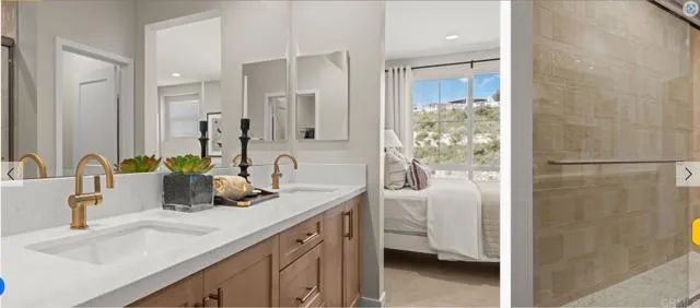 a bathroom with a double vanity sink mirror and