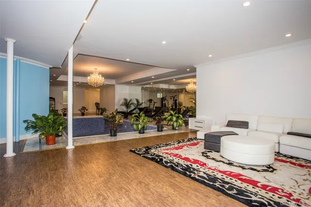 a lobby with furniture and a chandelier