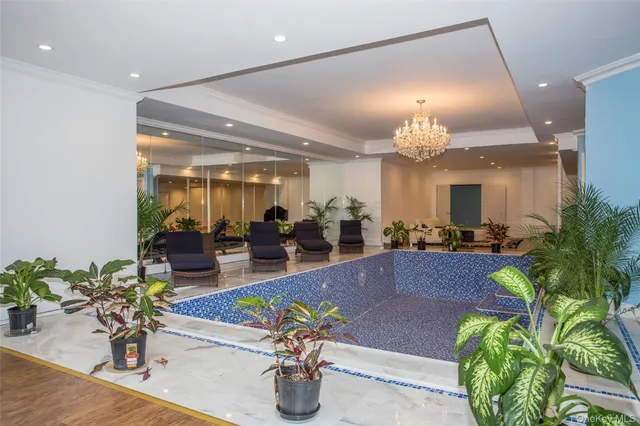 a front view of a house with garden and trees