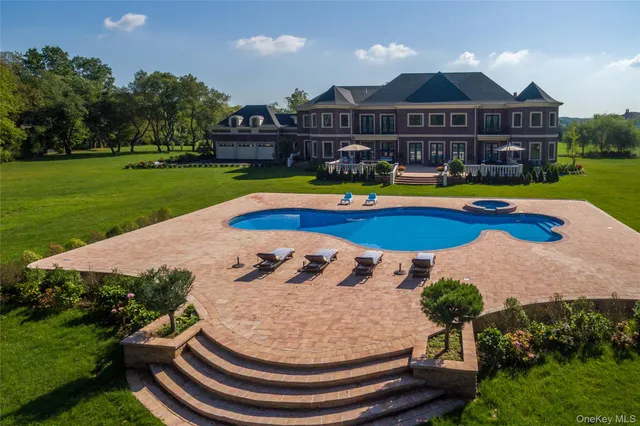 an aerial view of residential houses with outdoor space and trees