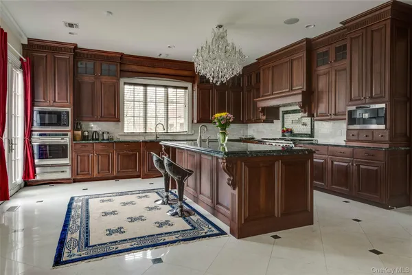 a living room with furniture chandelier and a chandelier