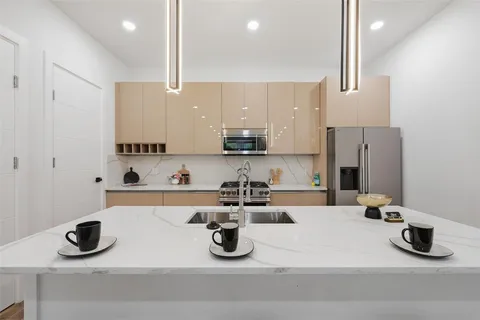 a kitchen with a sink a stove and cabinets