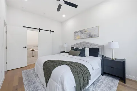 a bed room with a bed and a night stand