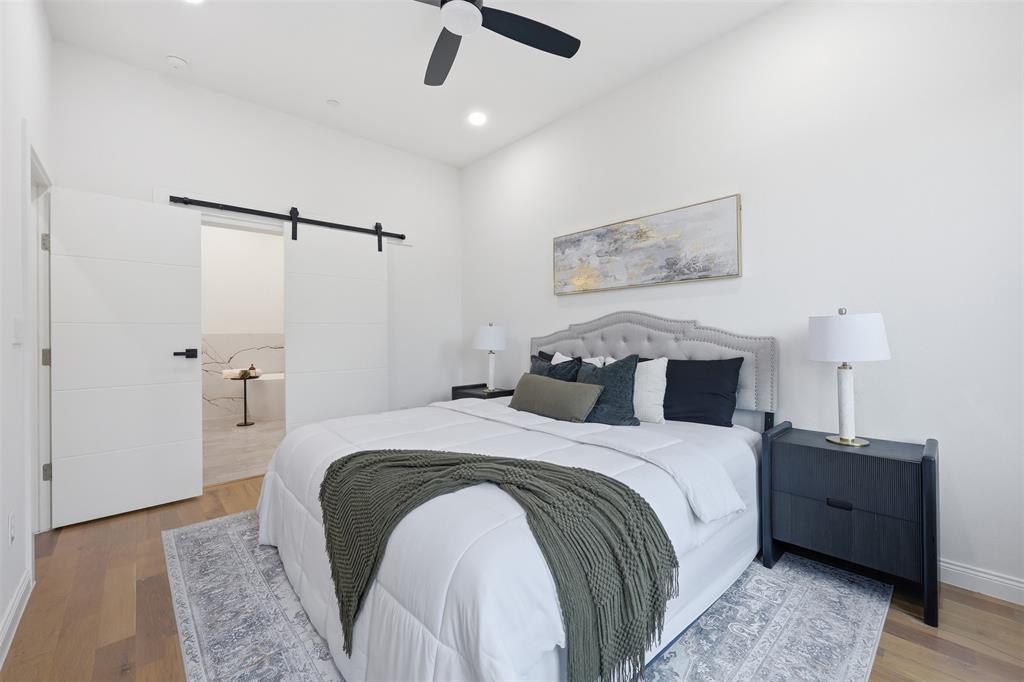 1920 Caddo Street, Unit 204 Dallas, TX 75204 - Photo 19 of 33 a bed room with a bed and a night stand
