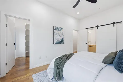 a bedroom with a bed and wooden floor