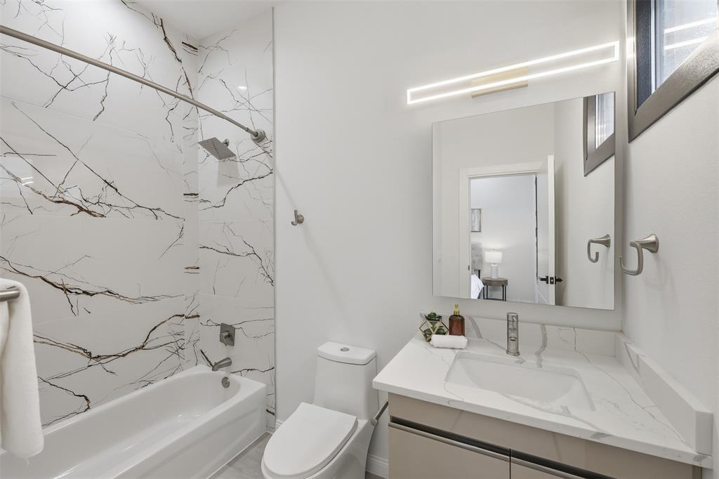 1920 Caddo Street, Unit 204 Dallas, TX 75204 - Photo 26 of 33 a bathroom with a sink toilet vanity and bathtub
