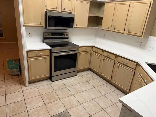 a kitchen with cabinets and appliances