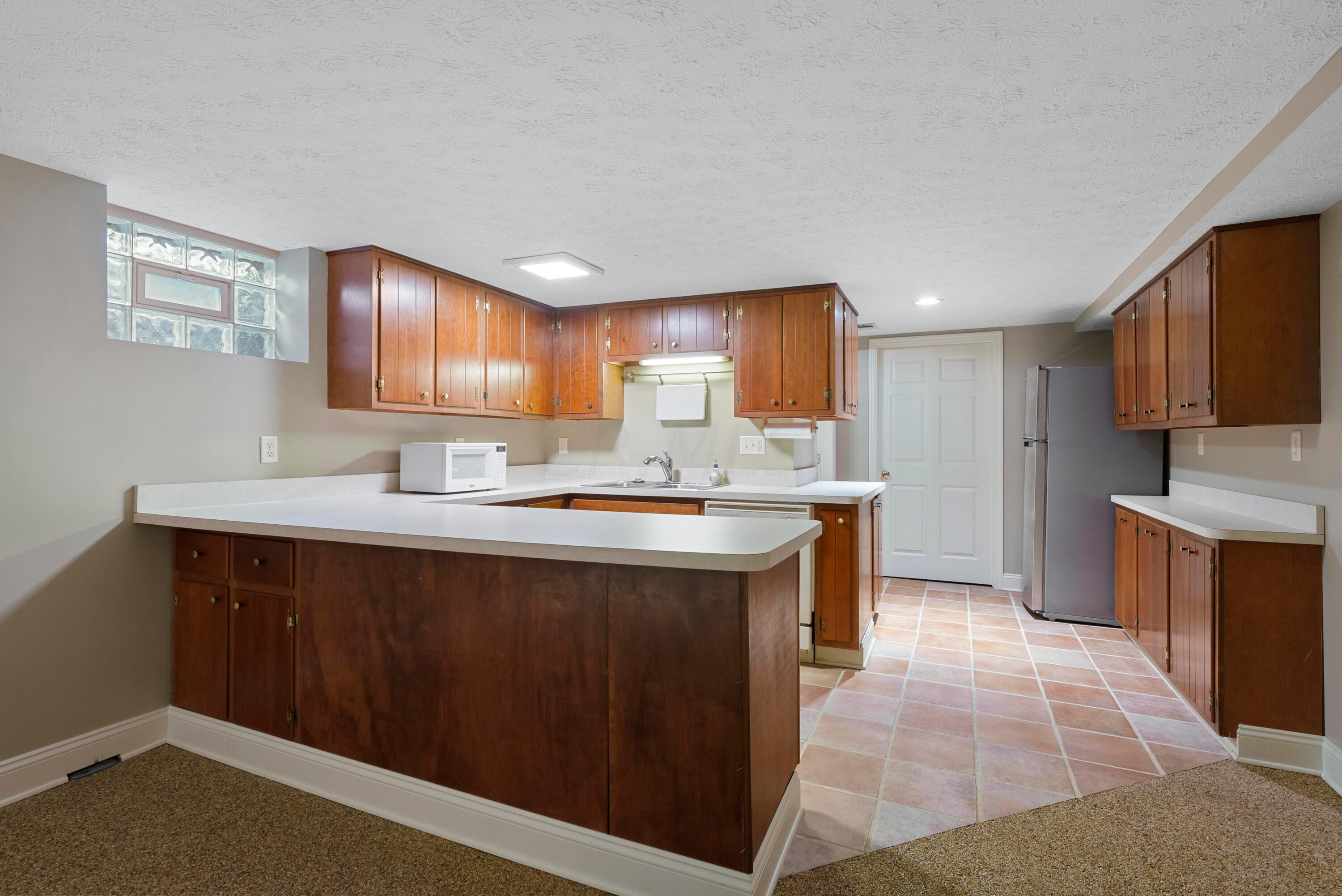 2718 Mt Holyoke Road Columbus, OH 43221 - Photo 35 of 57 Kitchen with fridge, dishwasher, microwave and sink- lower level