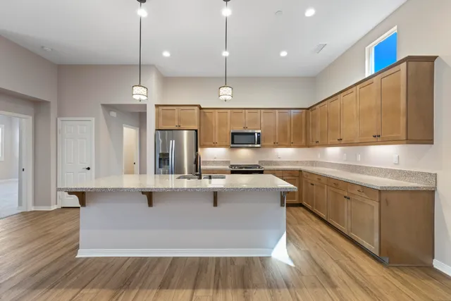 a kitchen with granite countertop a stove a sink and a microwave