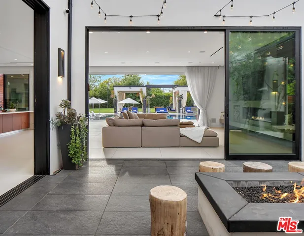 a living room with furniture and a floor to ceiling window