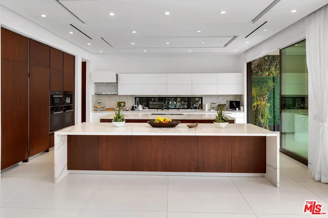 a living room with stainless steel appliances kitchen island granite countertop furniture and a view of kitchen