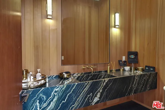 a view of living room and kitchen with stainless steel appliances