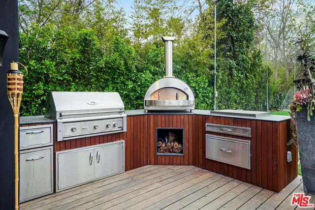 a view of a patio with table and chairs under an umbrella