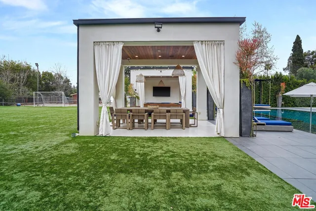 a view of a field with a trees in the background