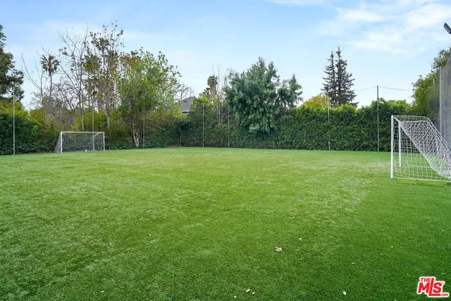 a view of a house with pool and chairs