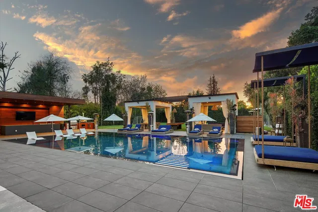 an aerial view of a house with swimming pool garden and patio
