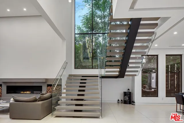 a living room with furniture and a floor to ceiling window